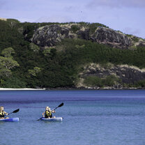 Students kayak in the Fiji Islands