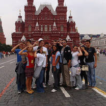 Group of students posing and saluting in Russia in front of building
