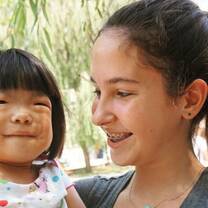 A woman and a child smiling together in China.