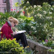 girl reading in a flower garden