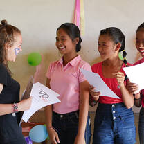 Volunteer Programs Bali, volunteer Johanna distributing certificates during Student of the Month awards.