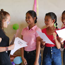 Volunteer Programs Bali, volunteer Johanna distributing certificates during Student of the Month awards.