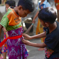 Volunteer in Bali. Our students helping each other get dressed for weekly clean up.