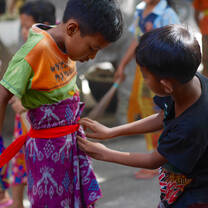 Volunteer in Bali. Our students helping each other get dressed for weekly clean up.