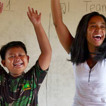 Volunteer Lidia and her student celebrating winning a classroom competition.