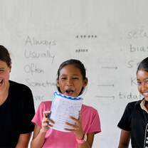 Volunteer Jess and her students having a laugh during a public speaking exercise!