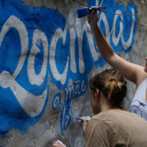 Volunteers painting a mural in Rio