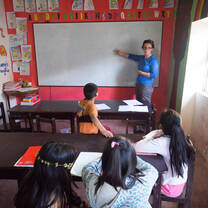 teaching pointing at whiteboard in classroom