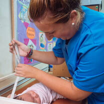 woman nurse working with baby