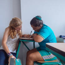 Teaching intern assisting child 