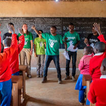 Volunteers teaching young students