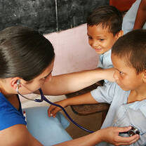 Volunteer using stethoscope in hospital in Belize