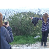 Friends enjoying golden hour from the top of Philopappos.