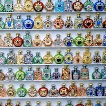 perfume jars on white shelves