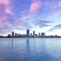Perth city view from across the water with a purple sunset sky 