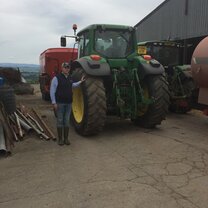 This is a image of myself and John Deere tractor that I got to work with on the same day of the dairy and learn different farming techniques