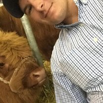 This is an image of myself and a highland cow at the Royal Highland Show