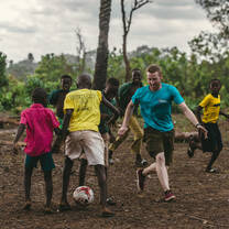Volunteer plying football at the local school