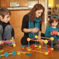 woman playing with two children