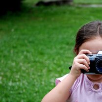 young girl taking photo