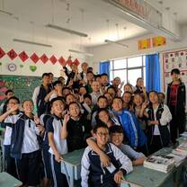 group of students posing in a classroom