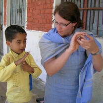 Volunteer teaching sign language India 