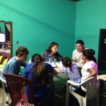 Teaching English to adults in a living room.