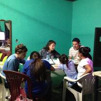Teaching English to adults in a living room.