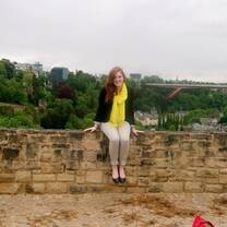 girl sitting on wall smiling