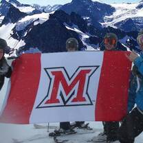 students skiing with miami flag