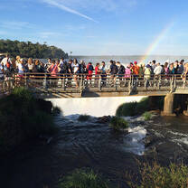 People walking through Iguazu Falls bridge in Argentina