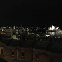 Nighttime view of the Sydney Harbor Bridge (far left) and the Sydney Opera House (far right) 