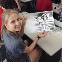 Student showing anime drawing