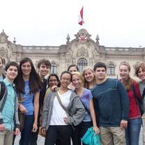 students pose in front of ornate building