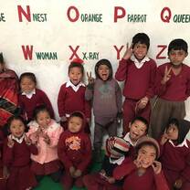 Students in Tolka pose for their teacher, Agatha