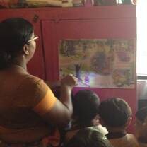 The teacher shines her torch