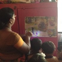 The teacher shines her torch