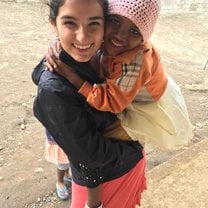 Volunteer holding girl