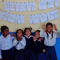 Students in one of our partner schools pose with silly faces