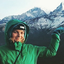 Elsa poses proudly with the mountains while trekking to her village