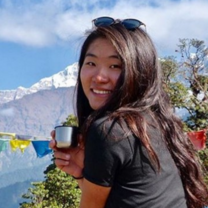 Trek to Teach-er , Reese, posing with tea by the mountains