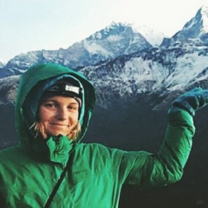 Elsa poses proudly with the mountains while trekking to her village
