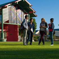 students talking on campus lawn