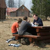 A volunteer with two children at Kitezh Children's Community