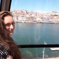 A woman posing in Porto, Portugal.