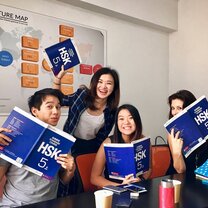 smiling-students-with-books-during-intensive-group-class