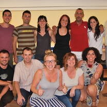 group of adults in two rows smiling