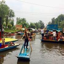 girl on a platform in a river with boats around