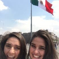 two girls smiling with the mexican flag