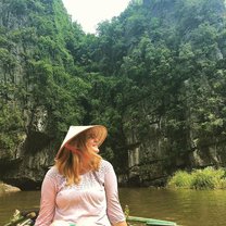 Girl on boat with Vietnamese hat